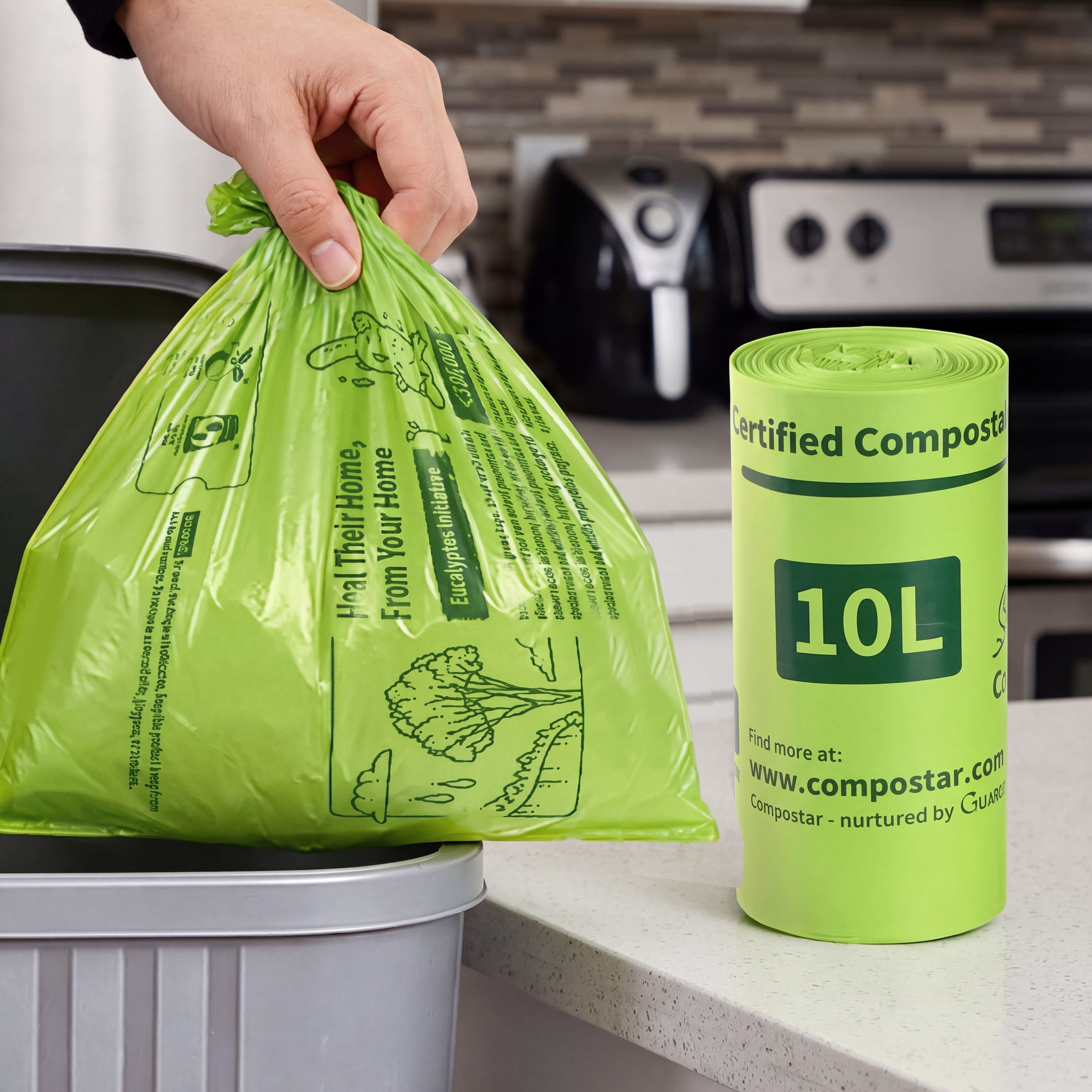 Robust 10L compostable FOGO bin liners being lifted from a small kitchen caddy