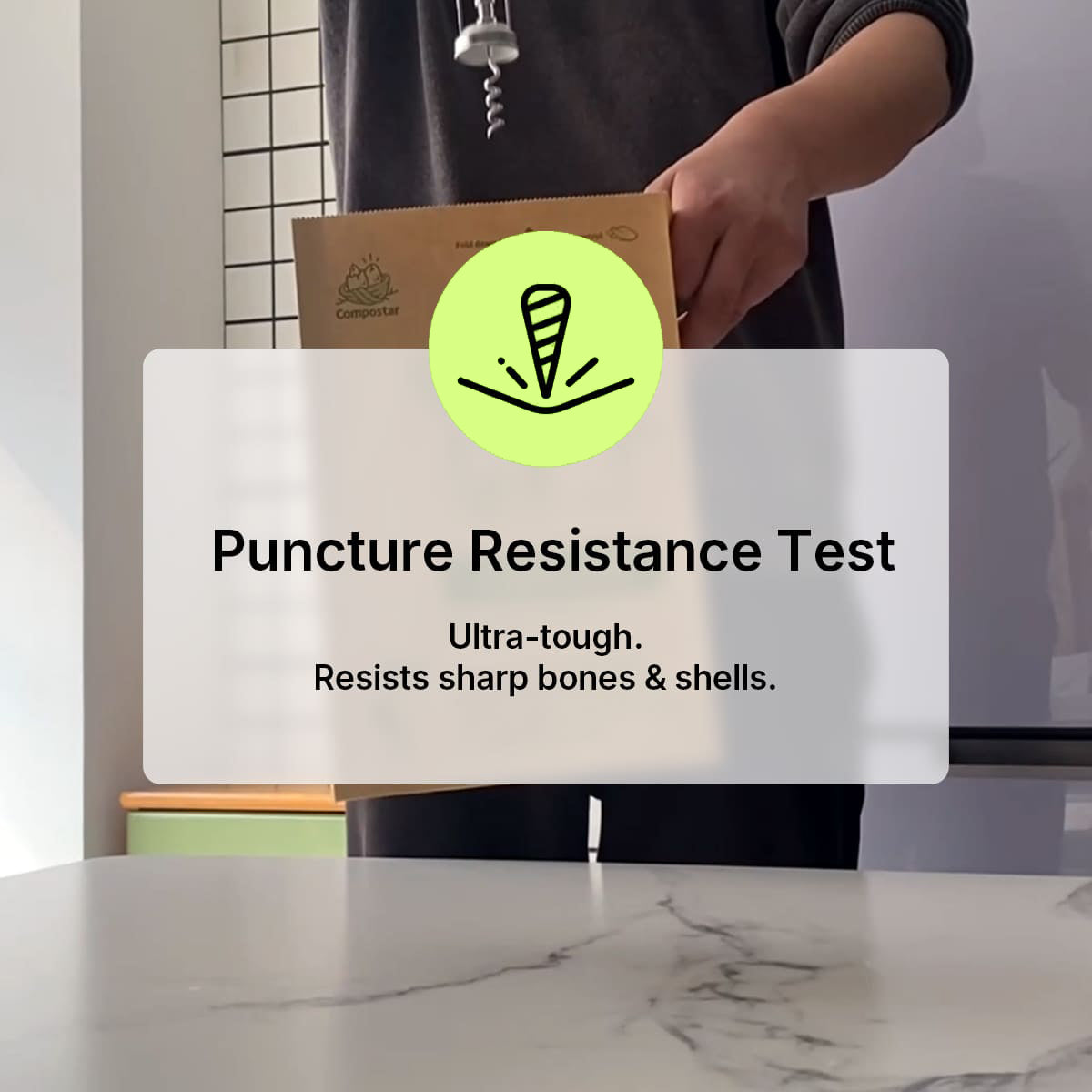 Load video: A person testing the puncture resistance of an ultra-tough Compostar FOGO bag, demonstrating how it resists sharp bones and shells without breaking.